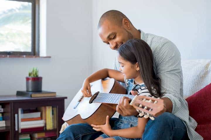 teaching kid to play guitar